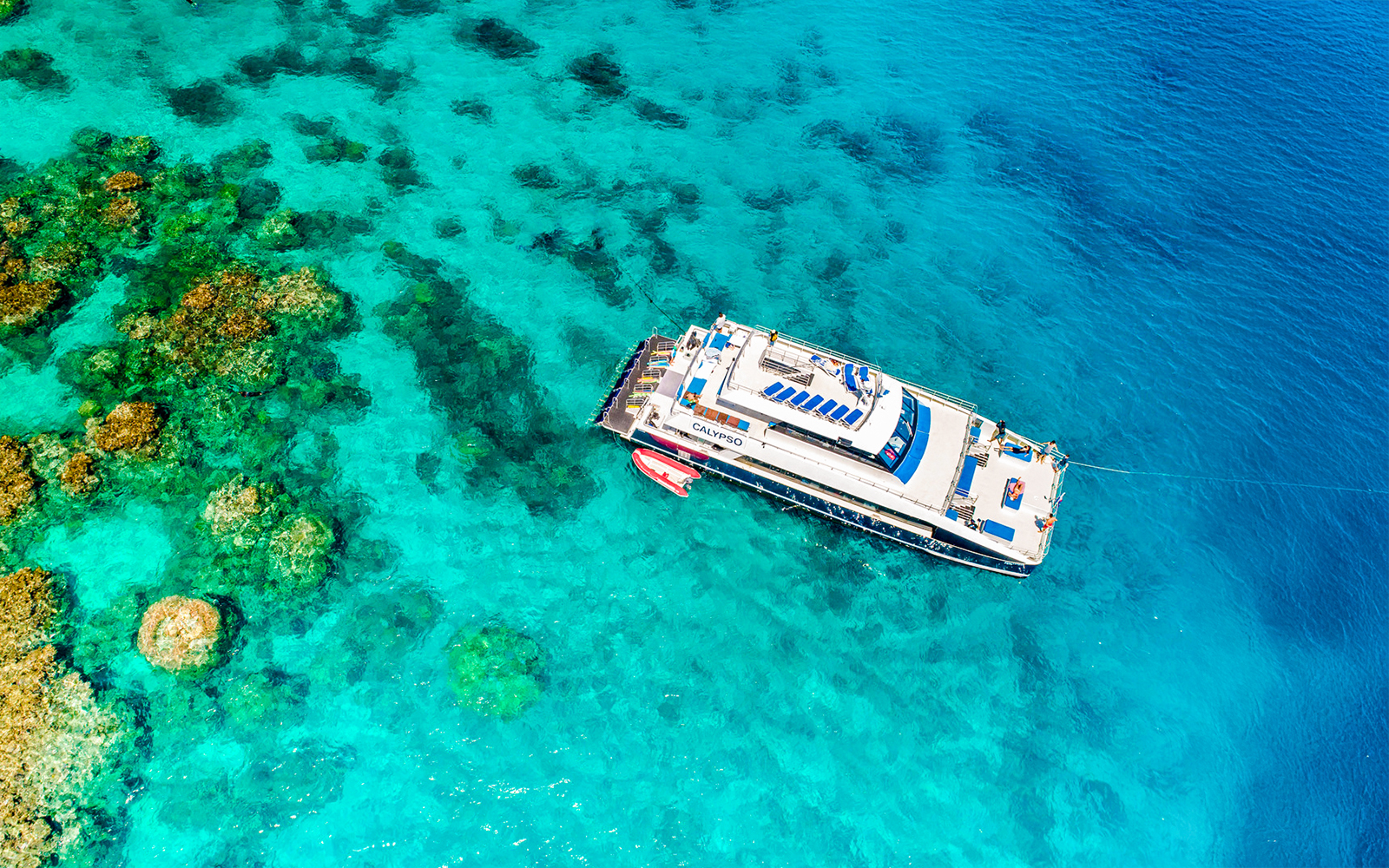 Cruise ship near coral reefs on Port Douglas to Low Isles Island route.