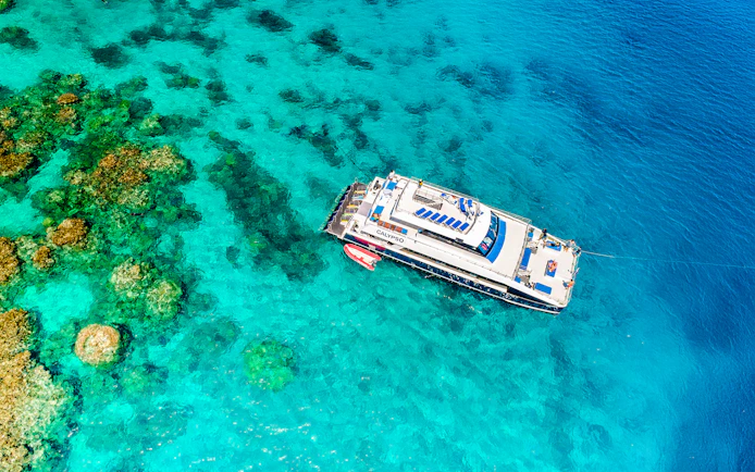 Cruise ship near coral reefs on Port Douglas to Low Isles Island route.