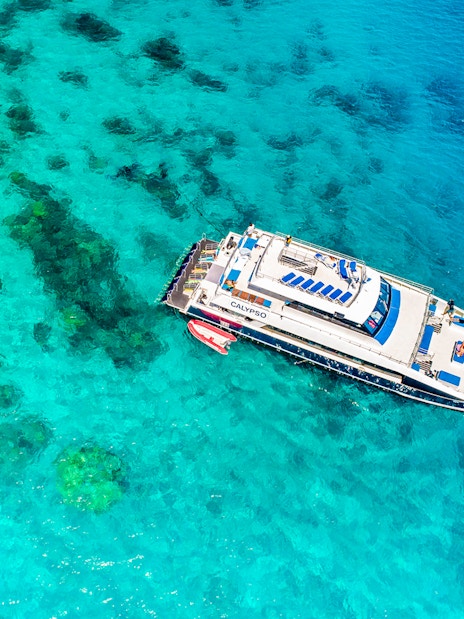 Cruise ship near coral reefs on Port Douglas to Low Isles Island route.