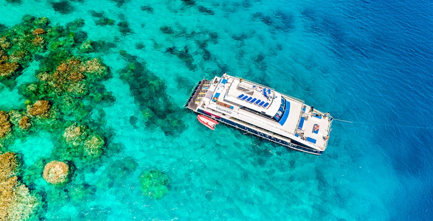 Cruise ship near coral reefs on Port Douglas to Low Isles Island route.