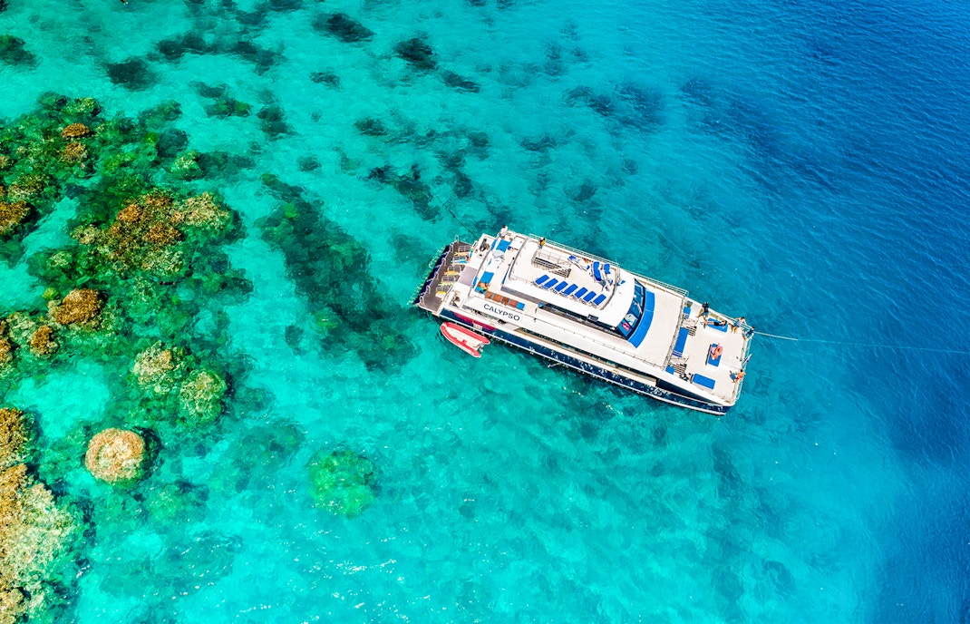 Cruise ship near coral reefs on Port Douglas to Low Isles Island route.
