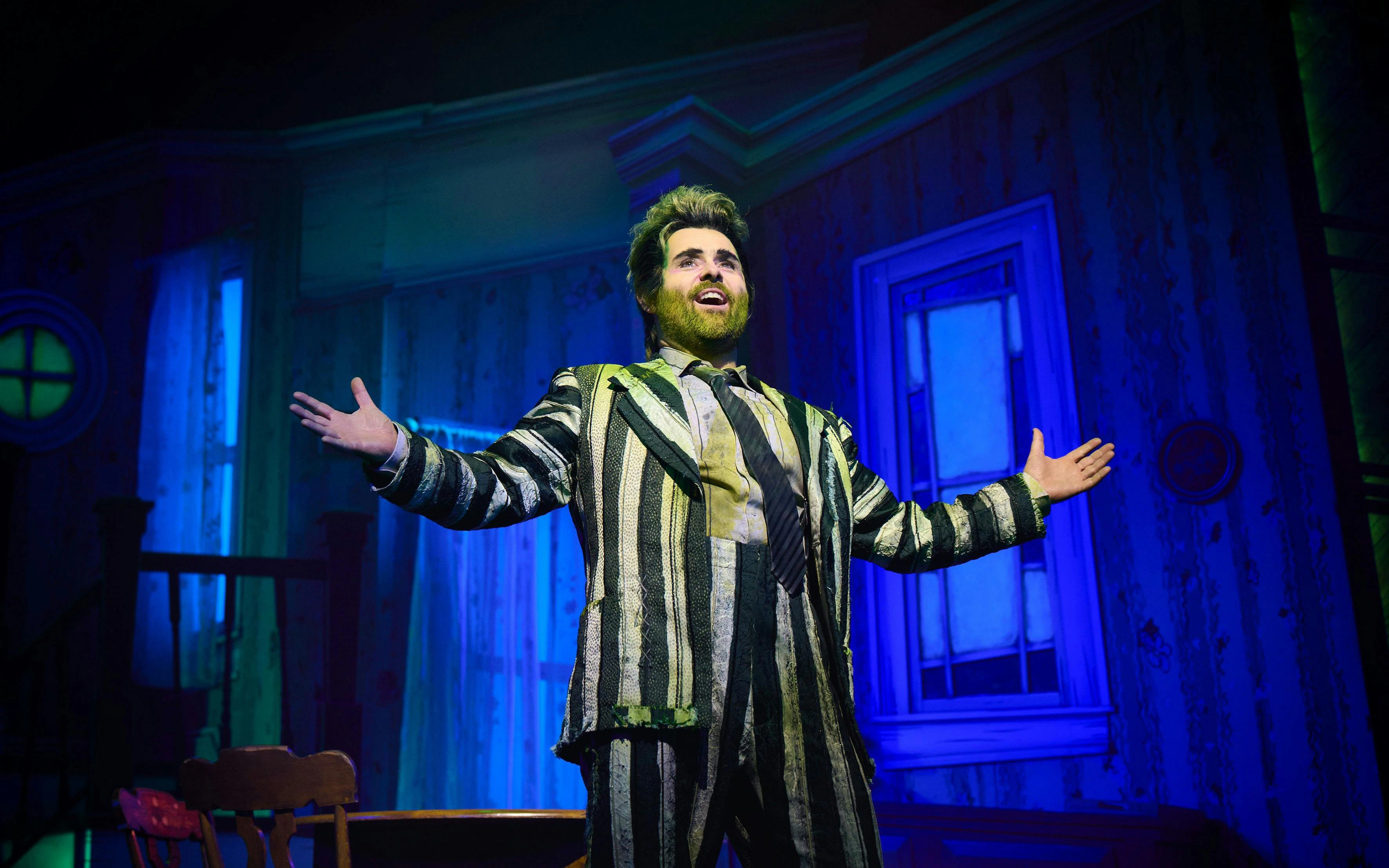 Performer in striped suit on stage during Beetlejuice show, West End.