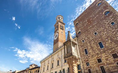 Lamberti Tower in Verona with clear blue sky.