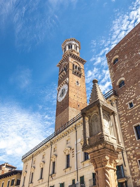 Lamberti Tower in Verona with clear blue sky.
