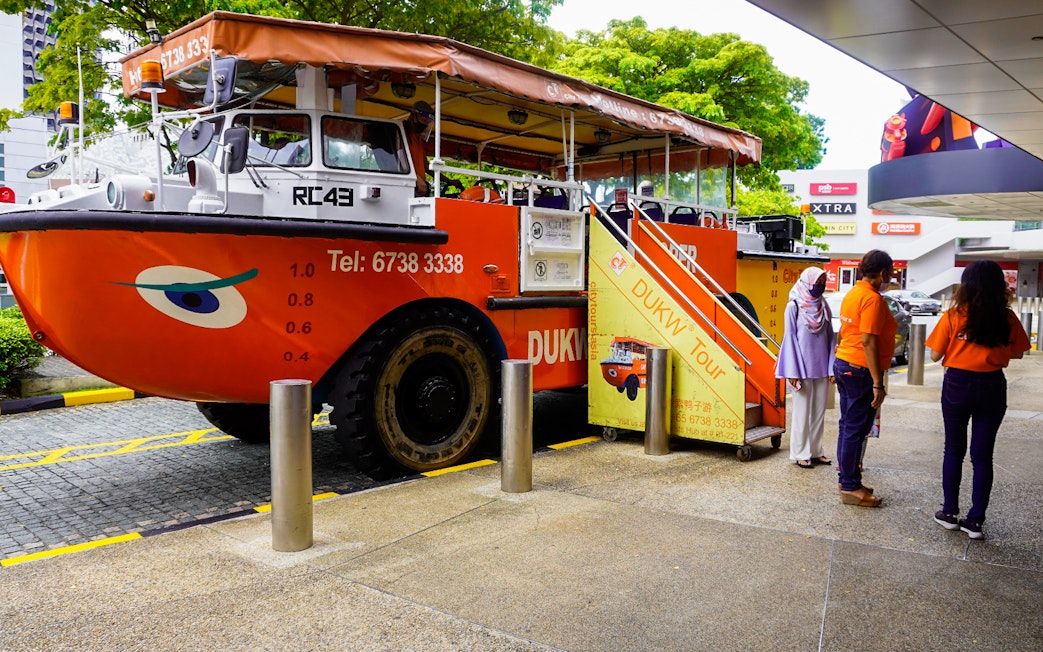 DUKW tour vehicle with passengers boarding in Singapore.