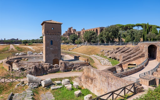 Circus Maximus ruins in Rome with ancient stone structures and a tower.