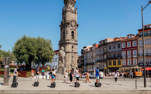 Tourists on Segways with guide near Clérigos Tower in Porto.