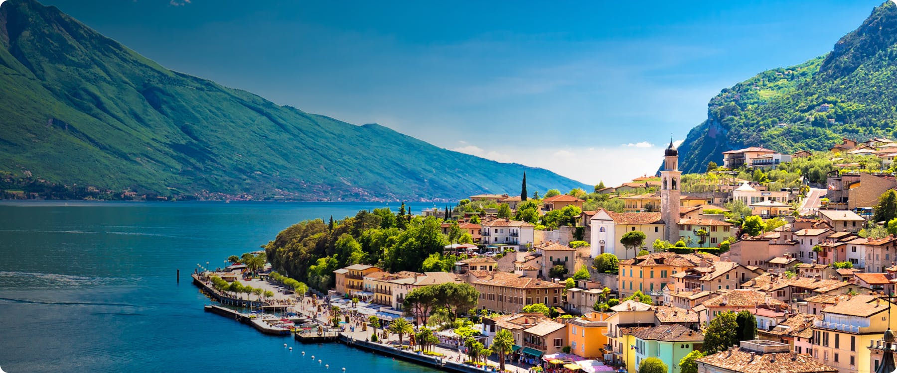 Sailboats on Lake Garda with mountains in the background, Italy.