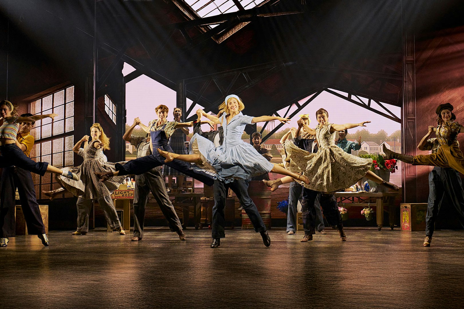 Cinderella stage performance in Madrid with dancers mid-leap in a vibrant scene.