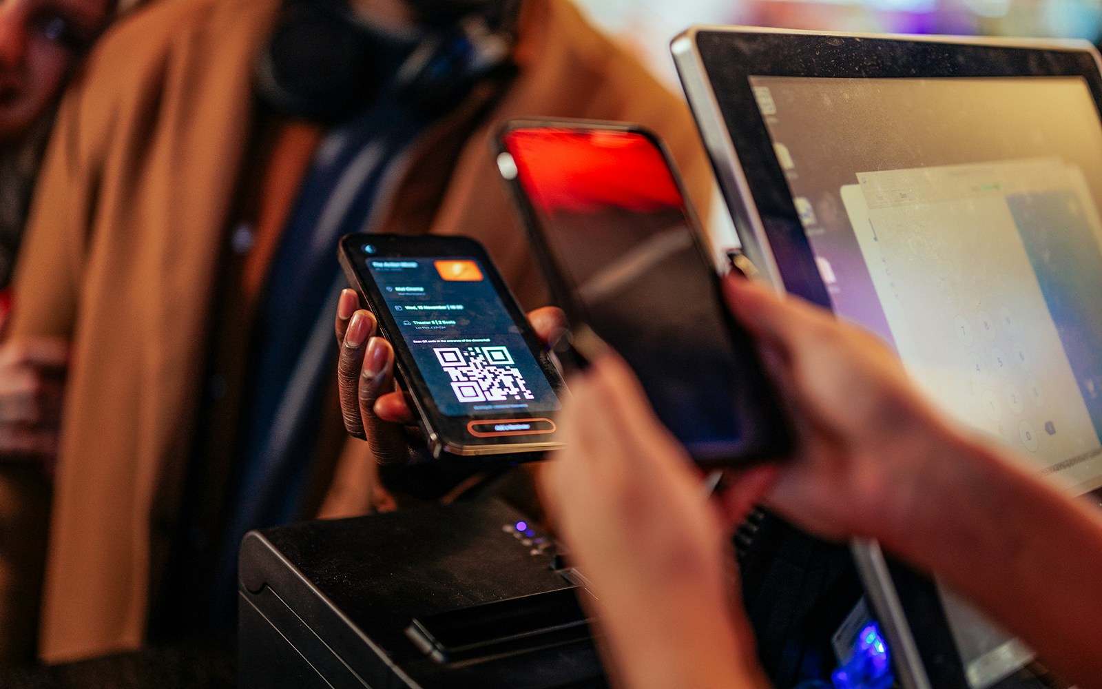 Mobile ticket scanning at a tour entrance with QR code on screen.