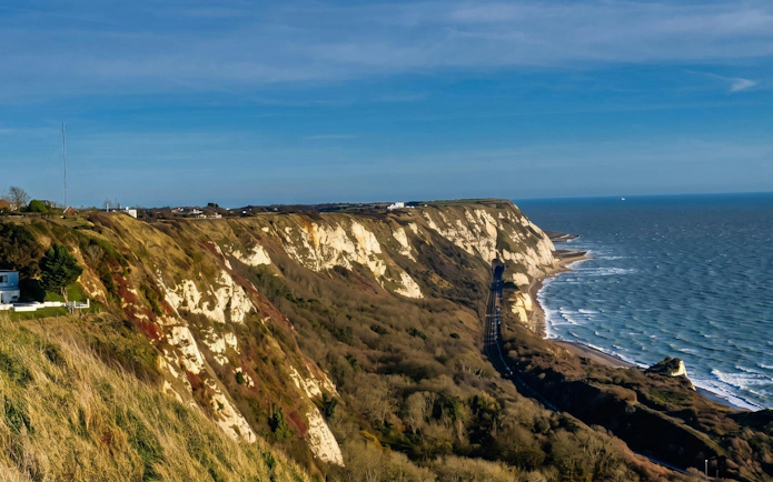 White cliffs of Dover overlooking the English Channel with coastal landscape.