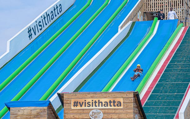 Visitors sliding down the slip 'n slide at Hatta Wadi Hub, Dubai.