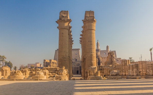Luxor Temple entrance with ancient columns under a clear sky, Egypt.