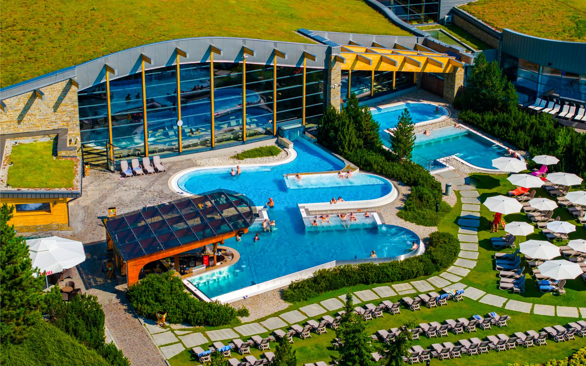 Guests relaxing in outdoor pools at Terma Bania, Zakopane.
