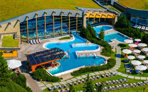 Guests relaxing in outdoor pools at Terma Bania, Zakopane.