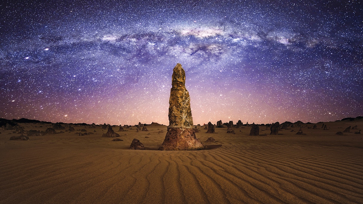 Pinnacles Desert under starry sky during sunset, Western Australia.