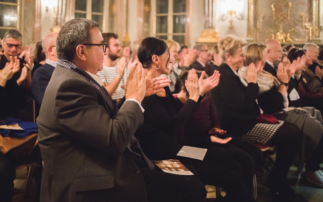 Audience applauding musicians at Mirabell Palace concert hall, Salzburg.
