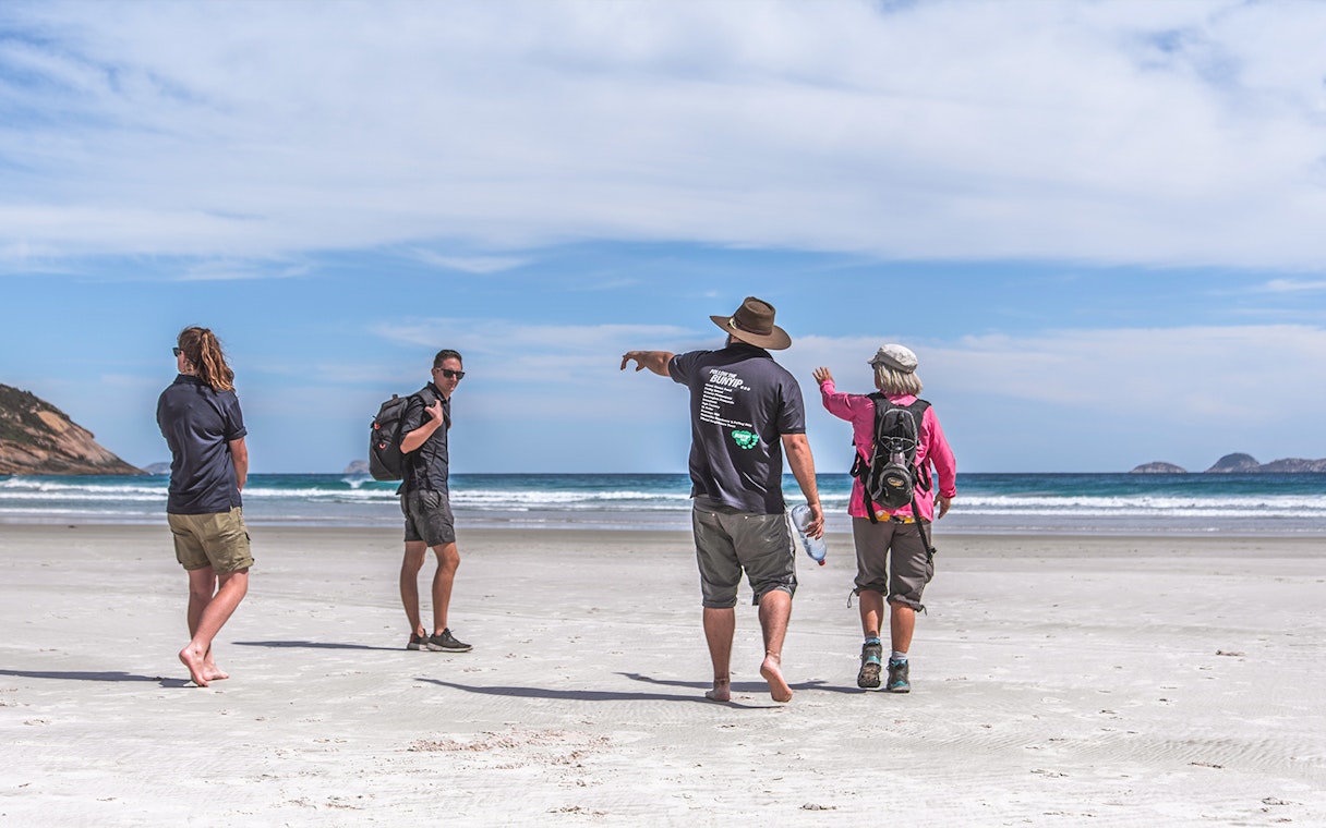 Group walking on a beach during Wilsons Promontory guided tour.
