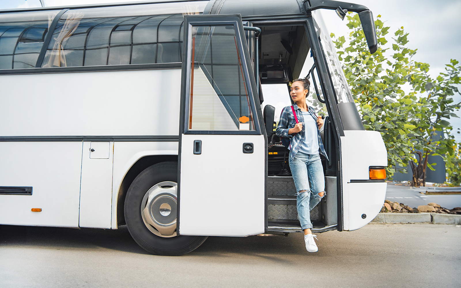 Tourist boarding coach at Tirana airport for Adventure Waterpark Desaru trip.