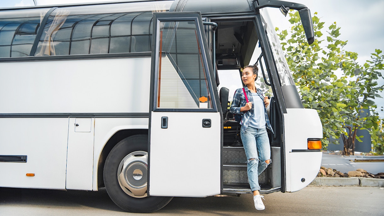 Tourist boarding coach at Tirana airport for Adventure Waterpark Desaru trip.
