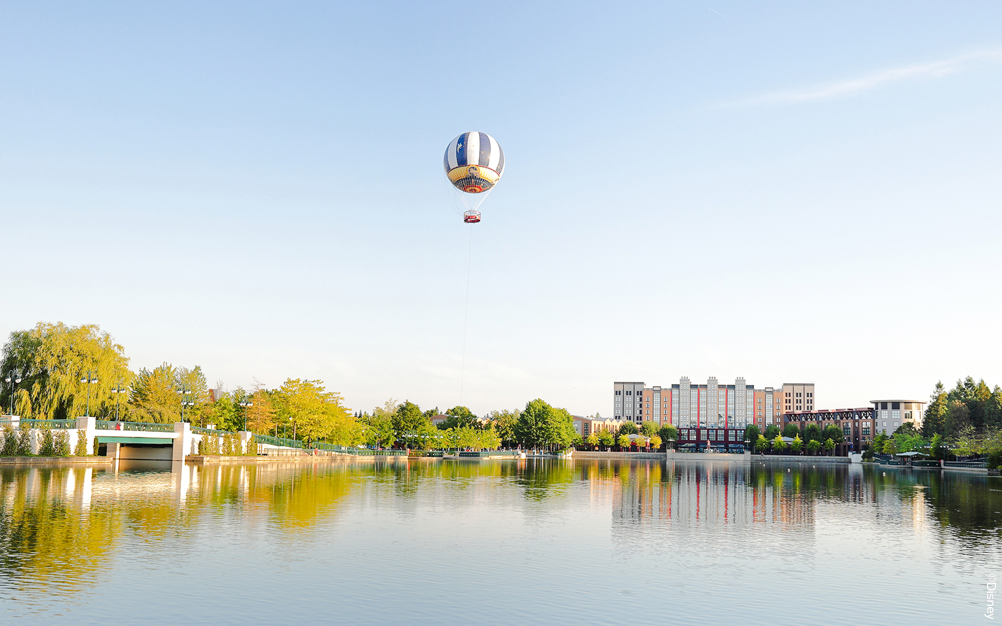 Balloon PanoraMagique floating over lake at Disneyland Paris, France.