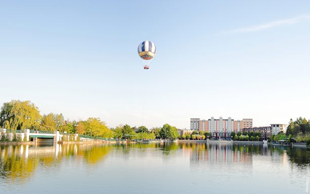 Balloon PanoraMagique floating over lake at Disneyland Paris, France.