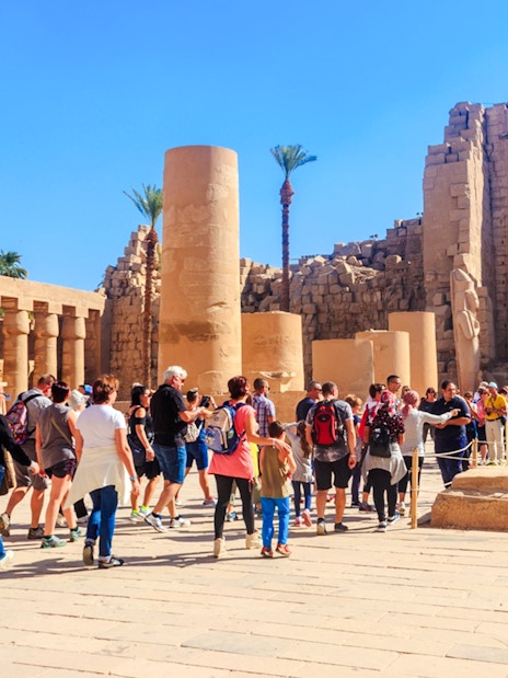 Visitors exploring Karnak Temple ruins during Luxor tour.