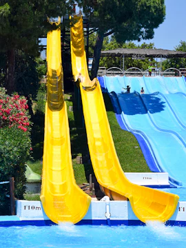 Water slides at Guadalpark Sevilla, Seville, with people enjoying the ride.