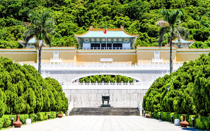 Taiwan National Palace Museum entrance with lush greenery in Taipei, Taiwan.