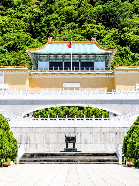 Taiwan National Palace Museum entrance with lush greenery in Taipei, Taiwan.
