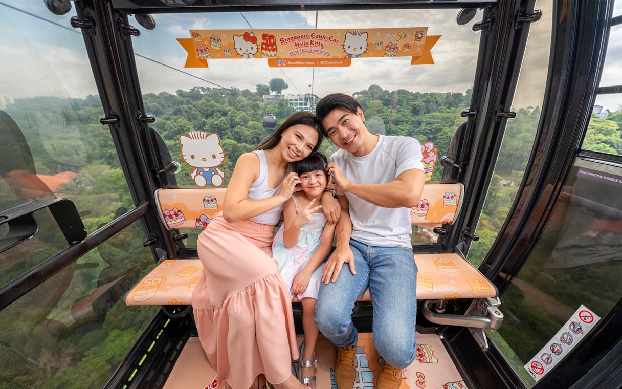 Family enjoying Singapore Cable Car with Hello Kitty theme.