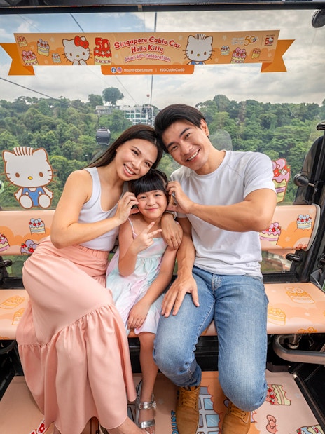 Family enjoying Singapore Cable Car with Hello Kitty theme.