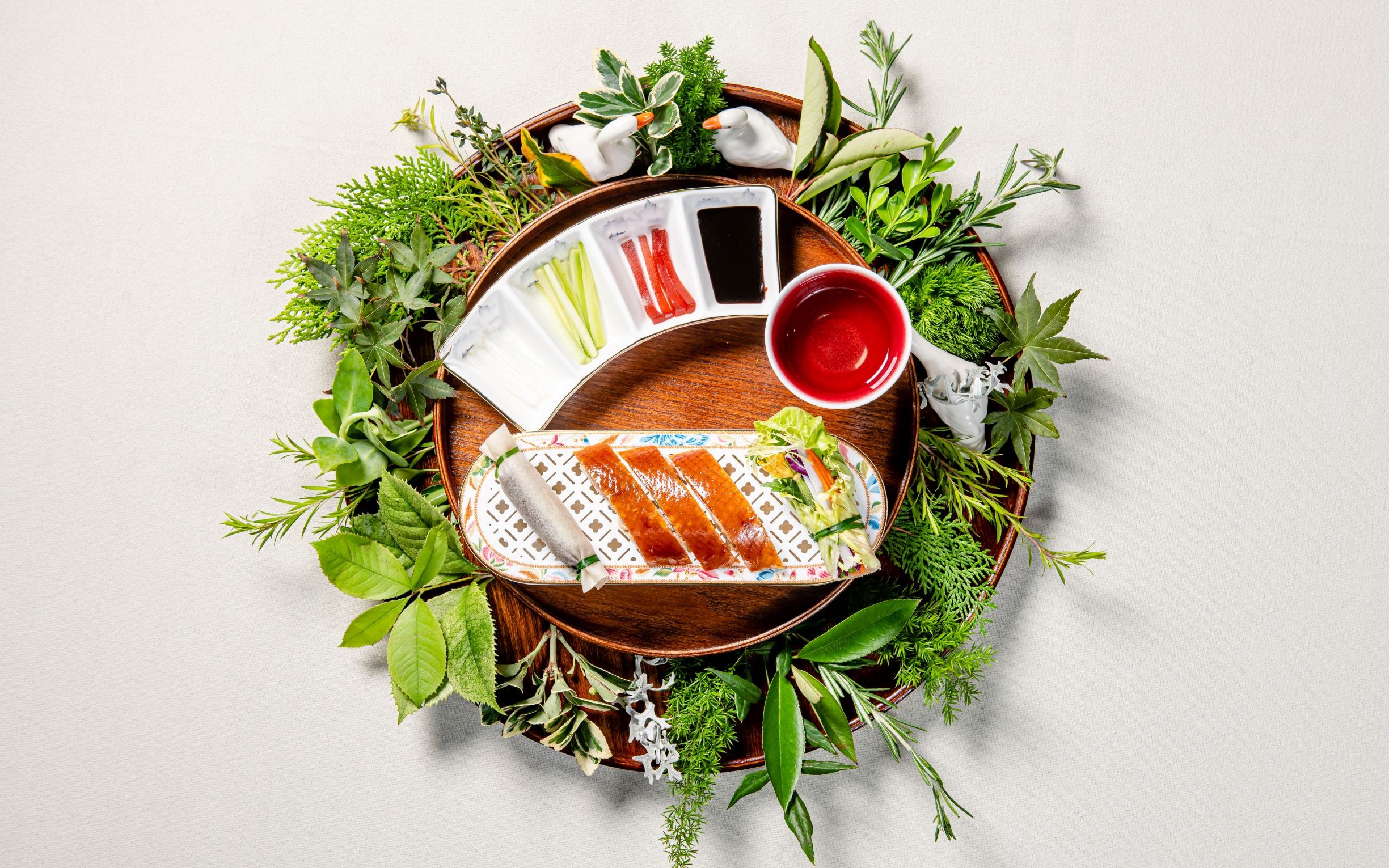 Crispy duck with sauces and herbs at "Taste of China" restaurant, Shanghai.