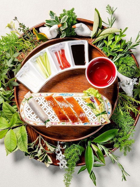 Crispy duck with sauces and herbs at "Taste of China" restaurant, Shanghai.