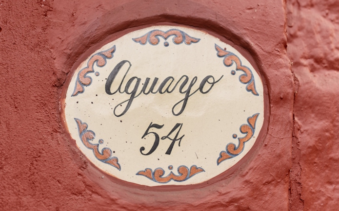 Aguayo 54 sign on red wall at Museo Casa Kahlo.