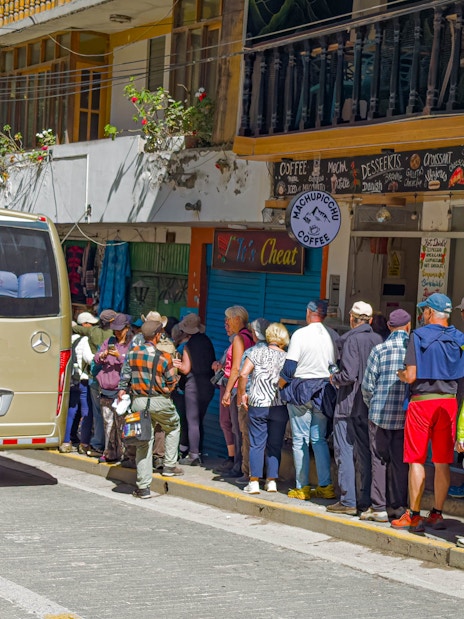 Tourists lining up to board a bus to Machu Picchu, Peru.