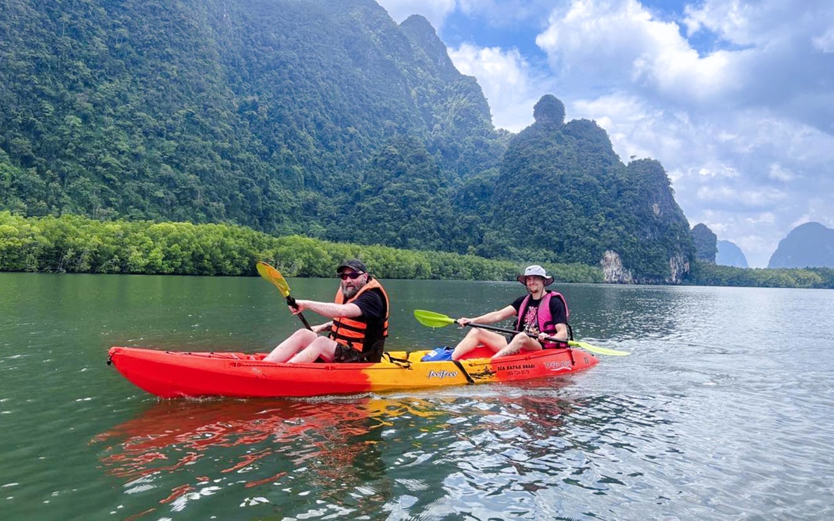 Tourists kayaking at Ao Thalane through mangrove forests in Thailand.