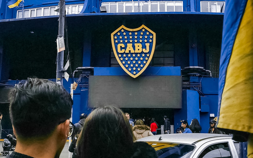 Couple outside La Bombonera stadium entrance in Buenos Aires.