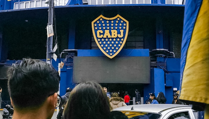Couple standing outside La Bombonera stadium in Buenos Aires, Argentina.
