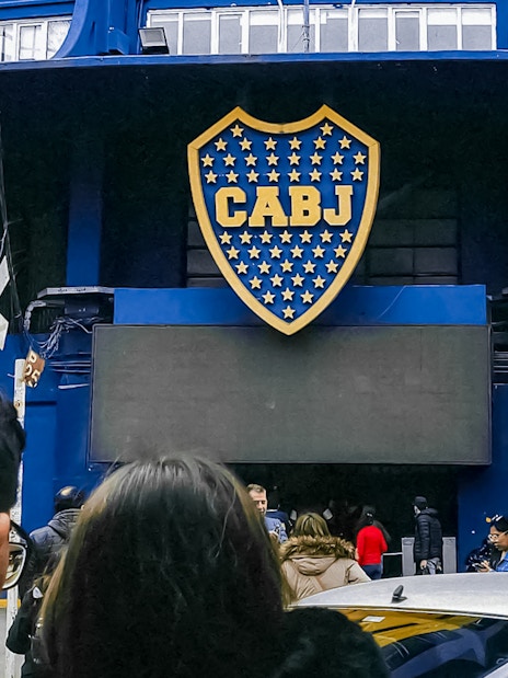 Couple outside La Bombonera stadium entrance in Buenos Aires.