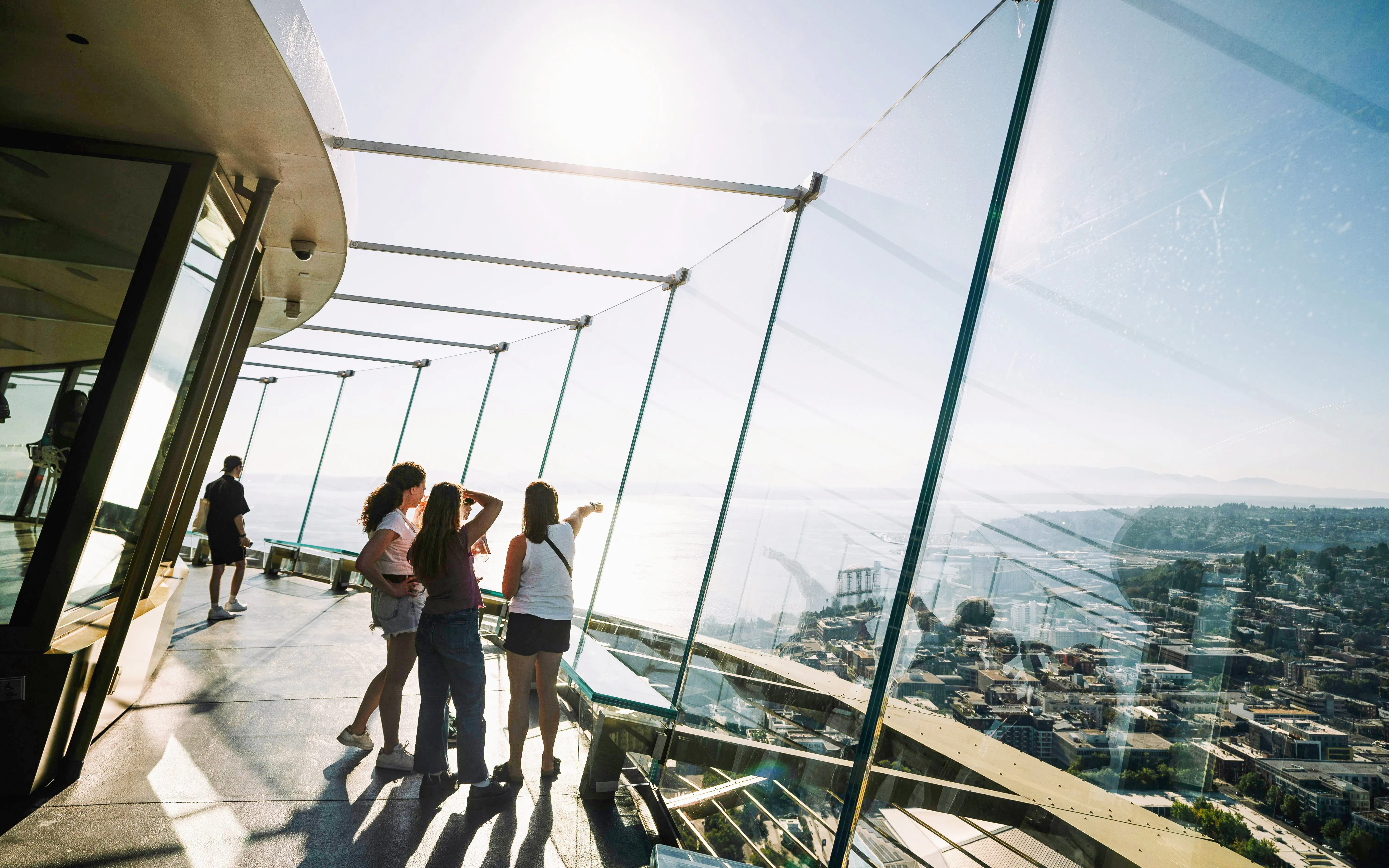 Visitors enjoying the view from the Space Needle observation deck in Seattle.