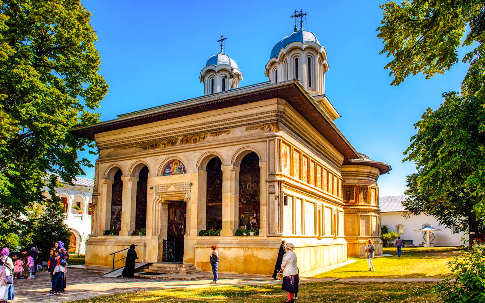 Snagov Monastery in Romania with visitors exploring the historic church and grounds.
