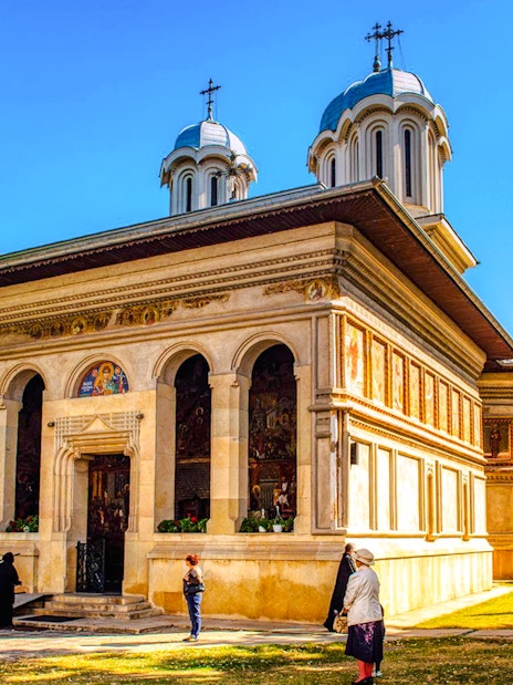 Snagov Monastery in Romania with visitors exploring the historic church and grounds.