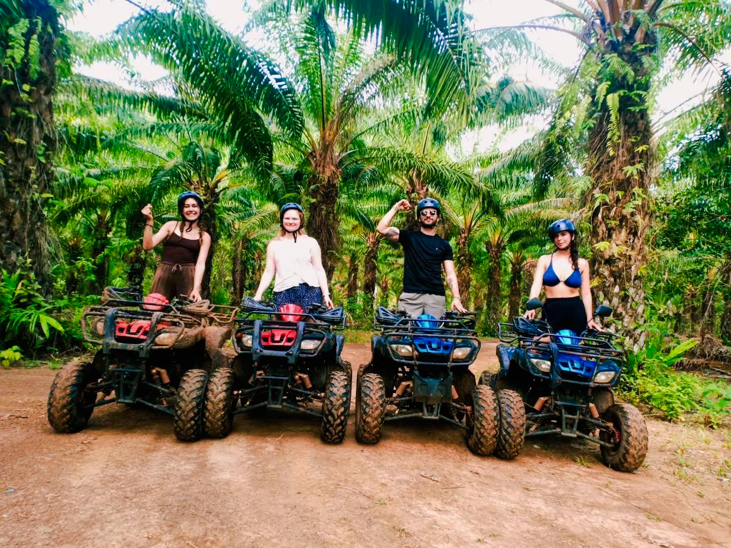 Group on ATVs in a lush Krabi forest during a half-day tour.