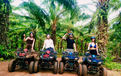 Group on ATVs in a lush Krabi forest during a half-day tour.