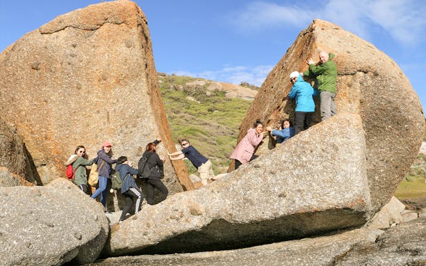 Group exploring rock formations at Wilsons Promontory National Park during a day tour from Melbourne.