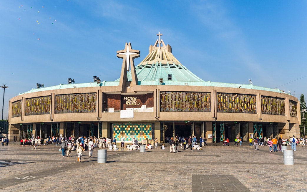 Basilica of Guadalupe exterior with visitors in Mexico City.