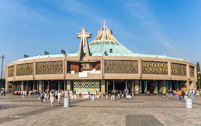 Basilica of Guadalupe exterior with visitors in Mexico City.