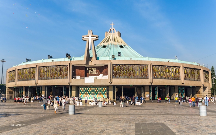Basilica of Guadalupe exterior with visitors in Mexico City.