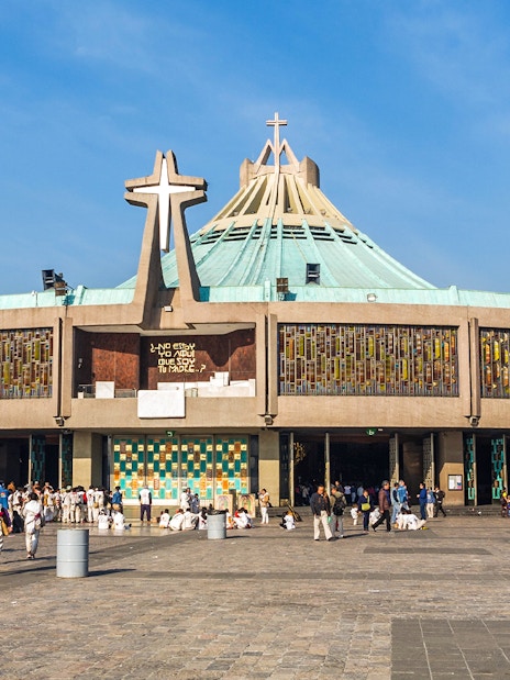 Basilica of Guadalupe exterior with visitors in Mexico City.